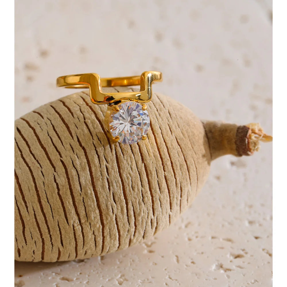 Cubic zirconia geometric ring in 18K gold-plated stainless steel with cubic zirconia.