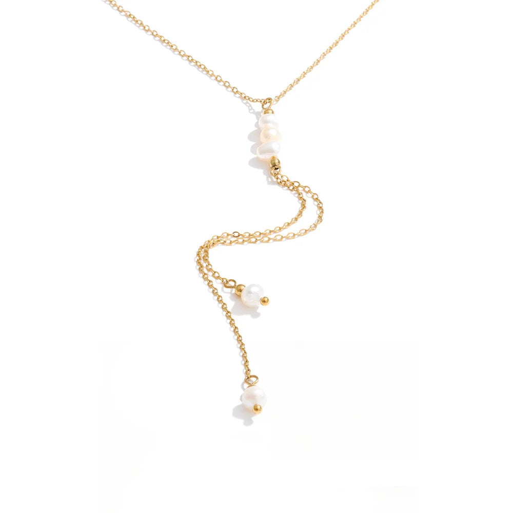 Gold-plated stainless steel necklace with freshwater pearl pendant featuring a delicate white flower design.