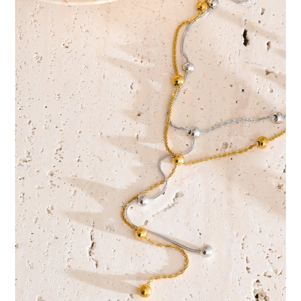 Beaded geometric chain necklace in gold-plated stainless steel.