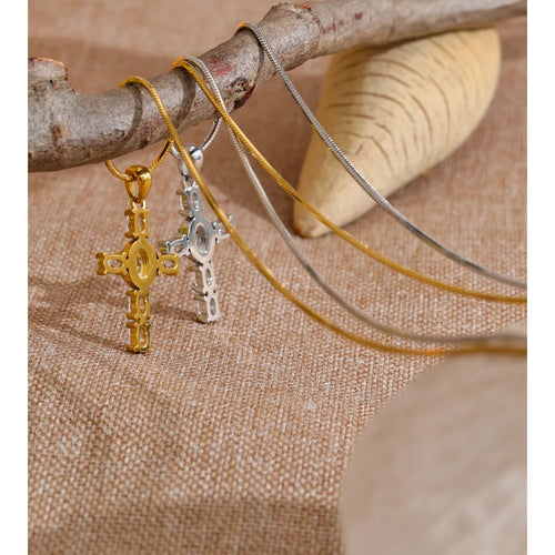 Cubic zirconia cross necklace in gold-plated stainless steel with cubic zirconia.
