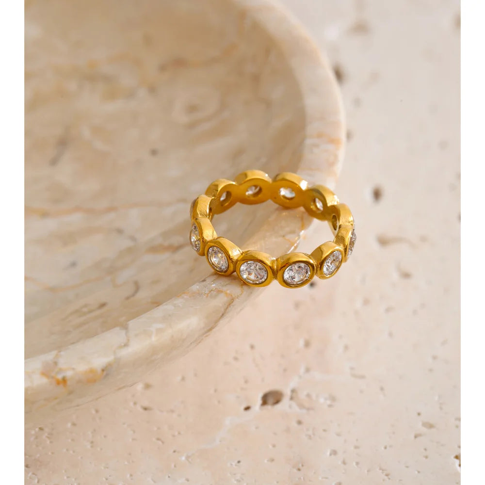 Cubic zirconia geometric ring in 18K gold-plated stainless steel with cubic zirconia.