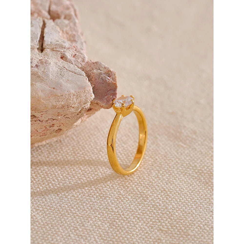 Cubic zirconia geometric ring in 18K gold-plated stainless steel with cubic zirconia.