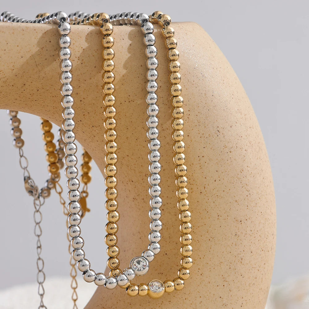 Cubic zirconia beaded geometric necklace in 18K gold-plated stainless steel with cubic zirconia.