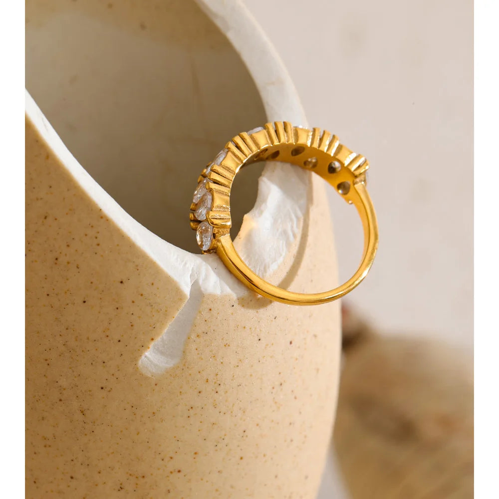 Cubic zirconia geometric ring in 18K gold-plated stainless steel with cubic zirconia.