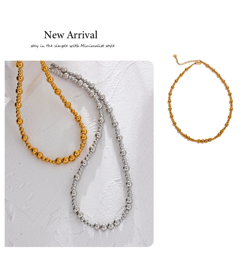 Beaded geometric chain necklace in gold-plated stainless steel.