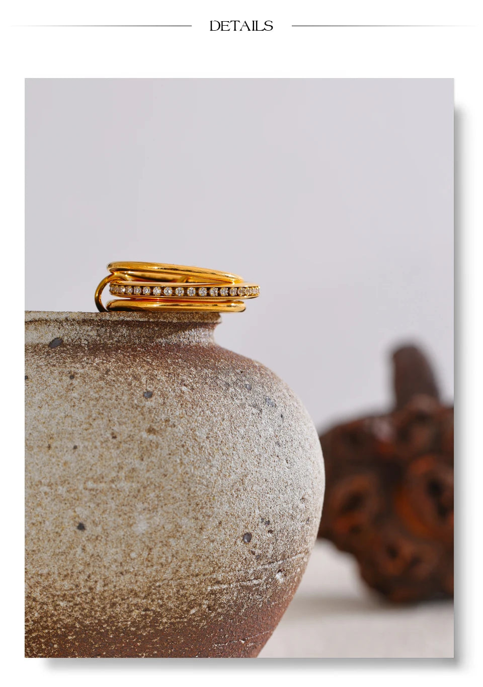 Cubic zirconia geometric layered ring in 18K gold-plated stainless steel with cubic zirconia.