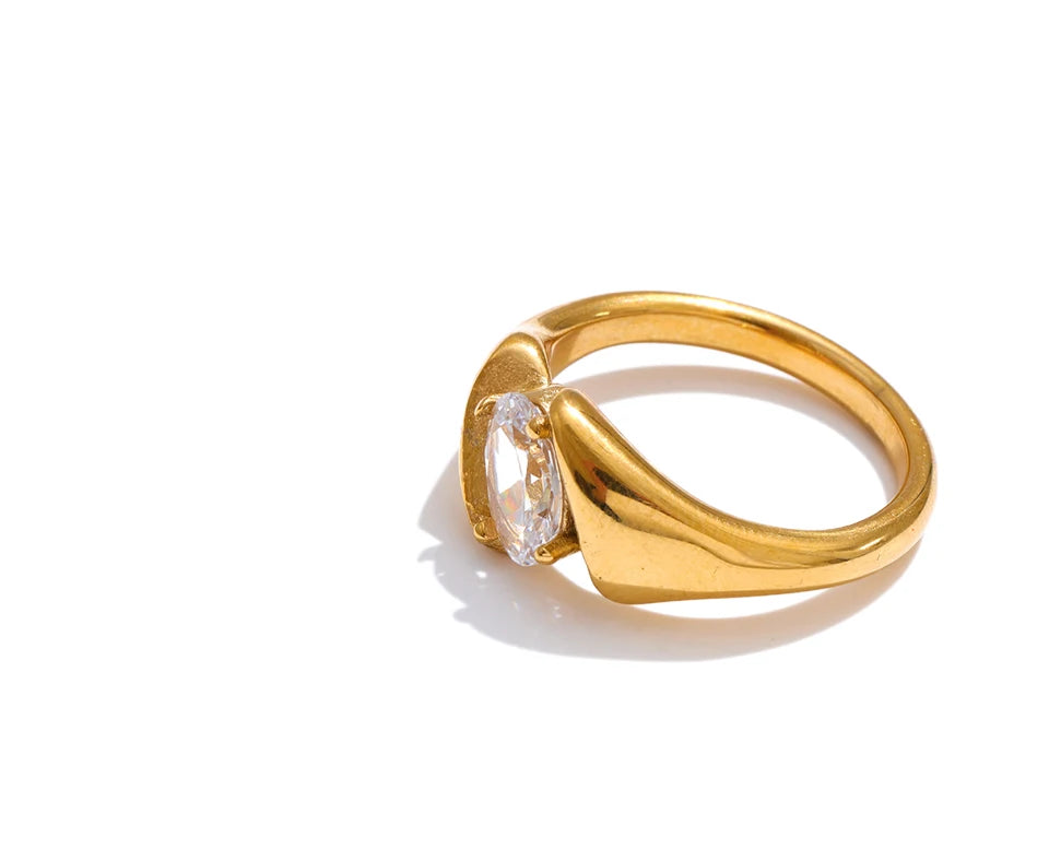 Cubic zirconia geometric ring in 18K gold-plated stainless steel with cubic zirconia.