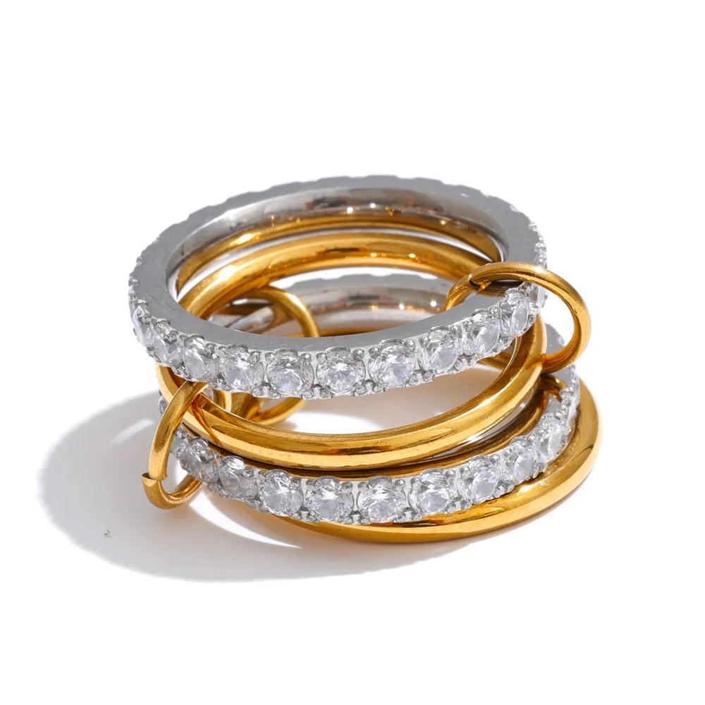Cubic zirconia geometric layered ring in 18K gold-plated stainless steel with cubic zirconia.