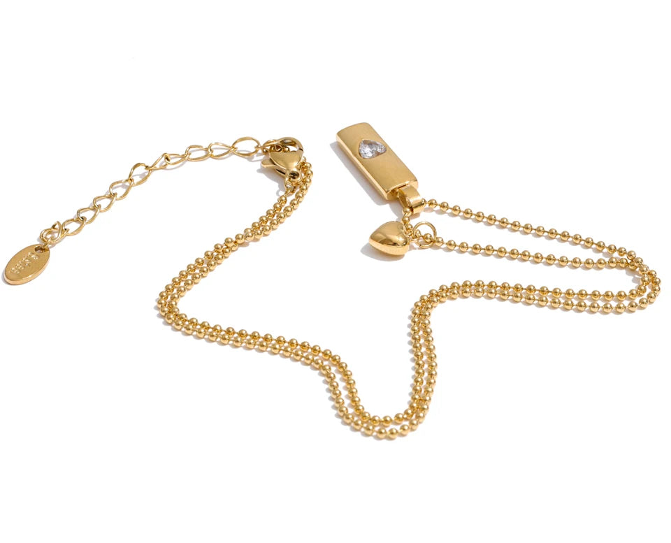 Cubic zirconia heart geometric necklace in gold-plated stainless steel with cubic zirconia.