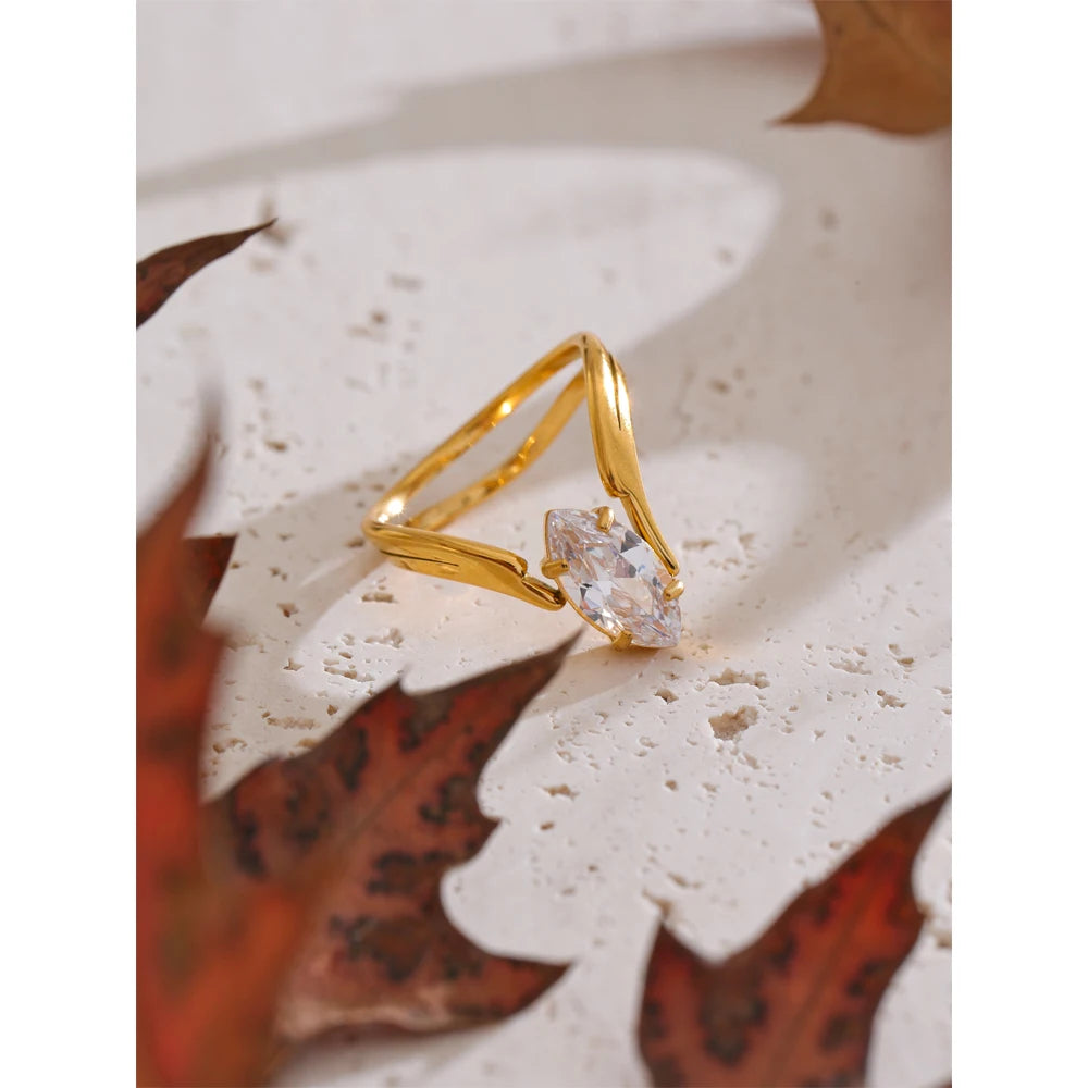 Cubic zirconia geometric ring in 18K gold-plated stainless steel with cubic zirconia.