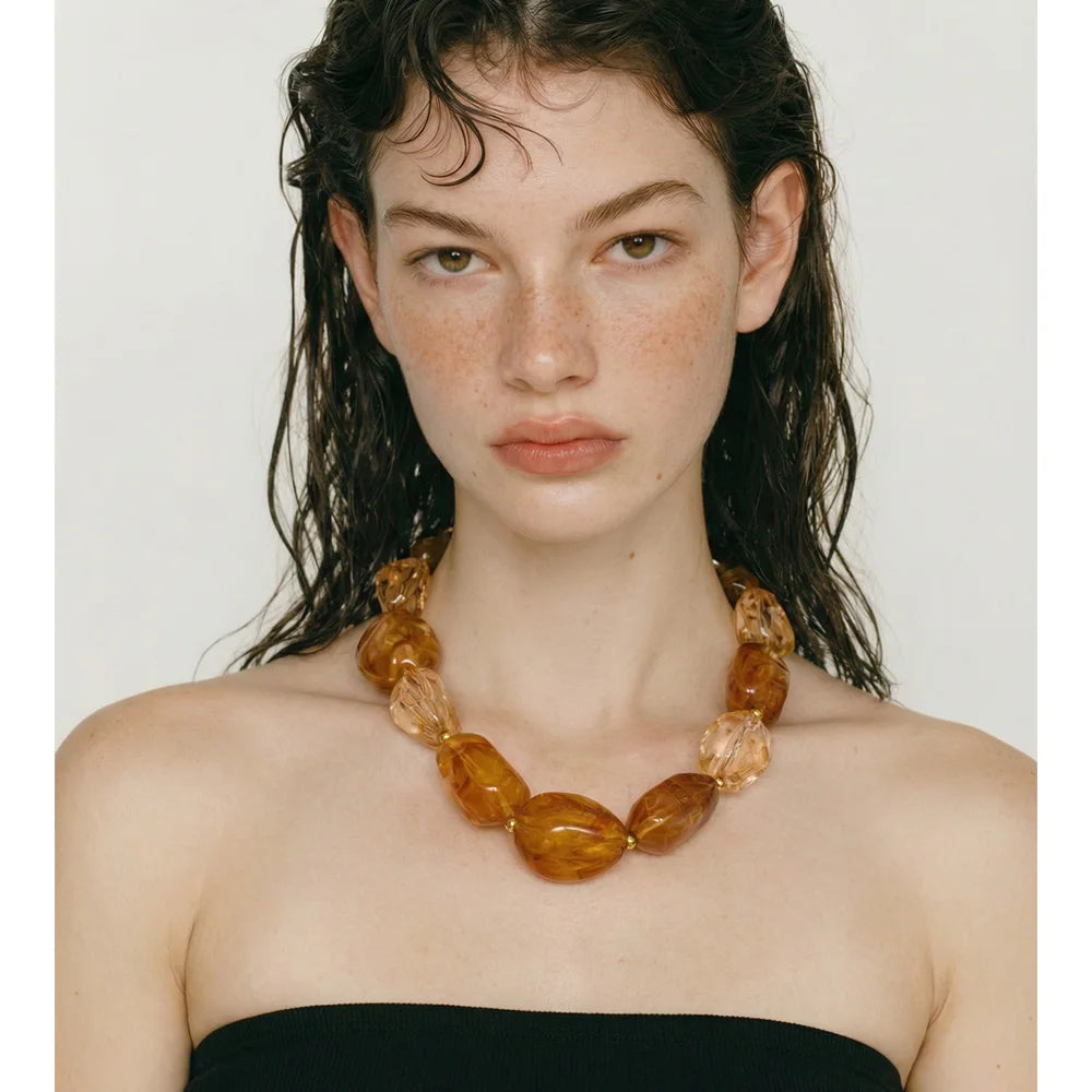 Resin acrylic geometric necklace in gold-plated stainless steel with resin and acrylic.