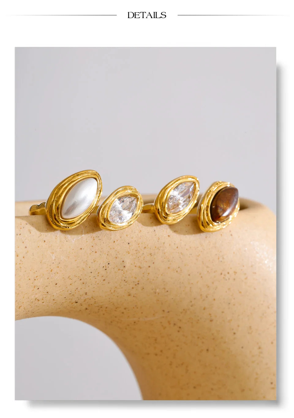 Cubic zirconia geometric ring in 18K gold-plated stainless steel with cubic zirconia.