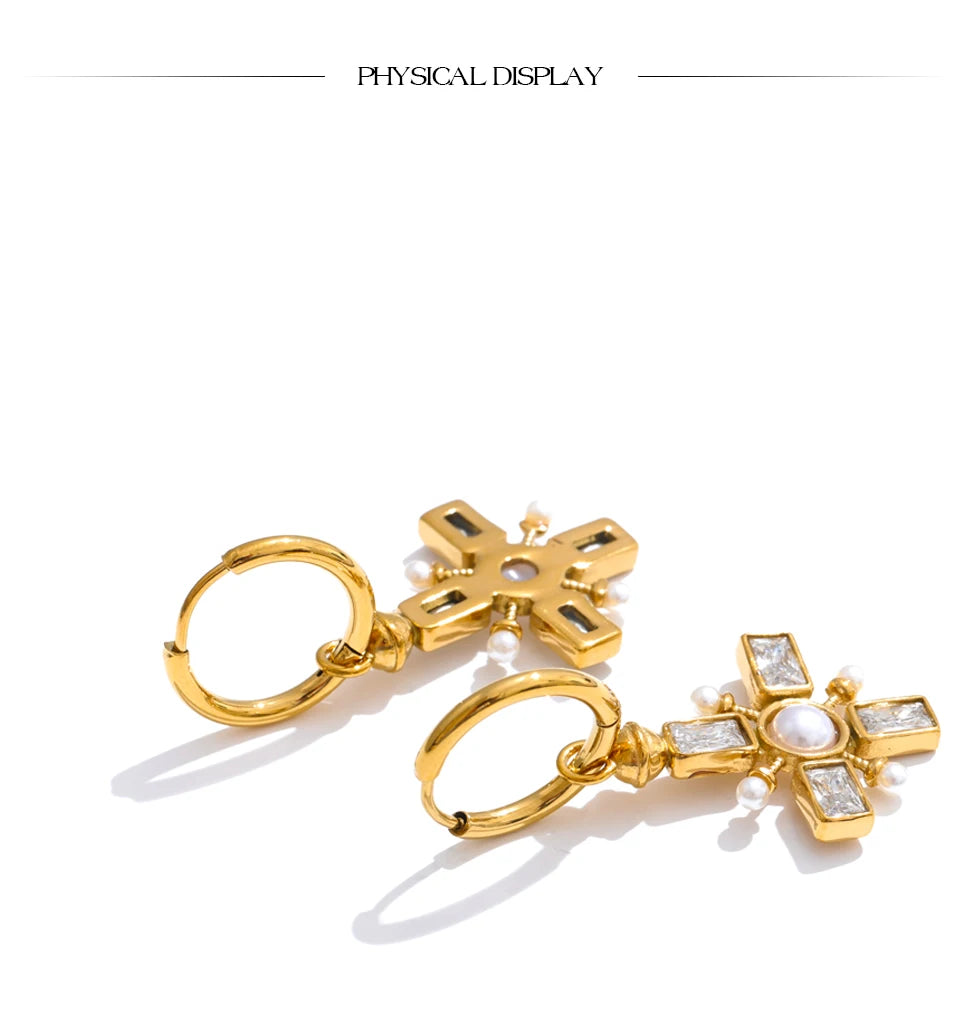 Cubic zirconia pearl cross earrings in gold-plated stainless steel with pearl and cubic zirconia.