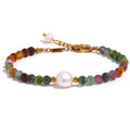 Pearl natural stone beaded bracelet in gold-plated stainless steel with pearl and natural stone.