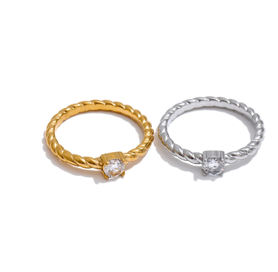 Cubic zirconia geometric ring in 18K gold-plated stainless steel with cubic zirconia.