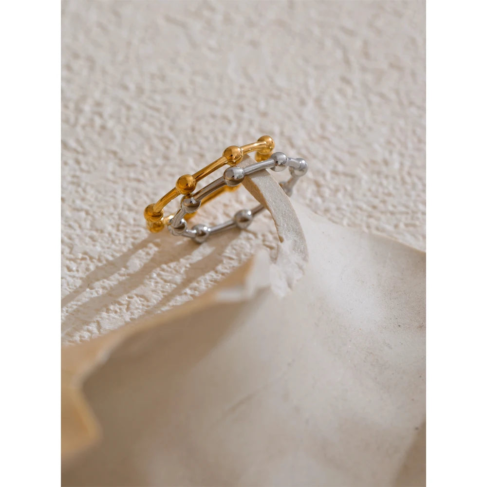 Beaded minimalist geometric ring in 18K gold-plated stainless steel.