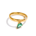 Green cubic zirconia geometric ring in 18K gold-plated stainless steel with cubic zirconia.