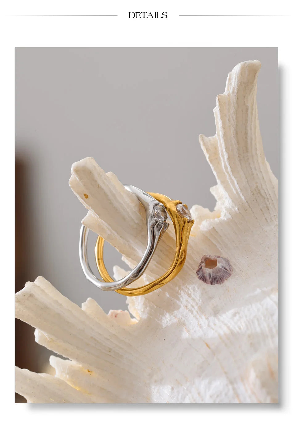 Cubic zirconia geometric ring in 18K gold-plated stainless steel with cubic zirconia.