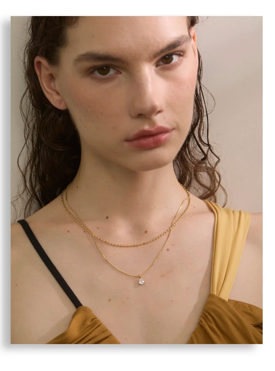 Cubic zirconia geometric layered necklace in gold-plated stainless steel with cubic zirconia.