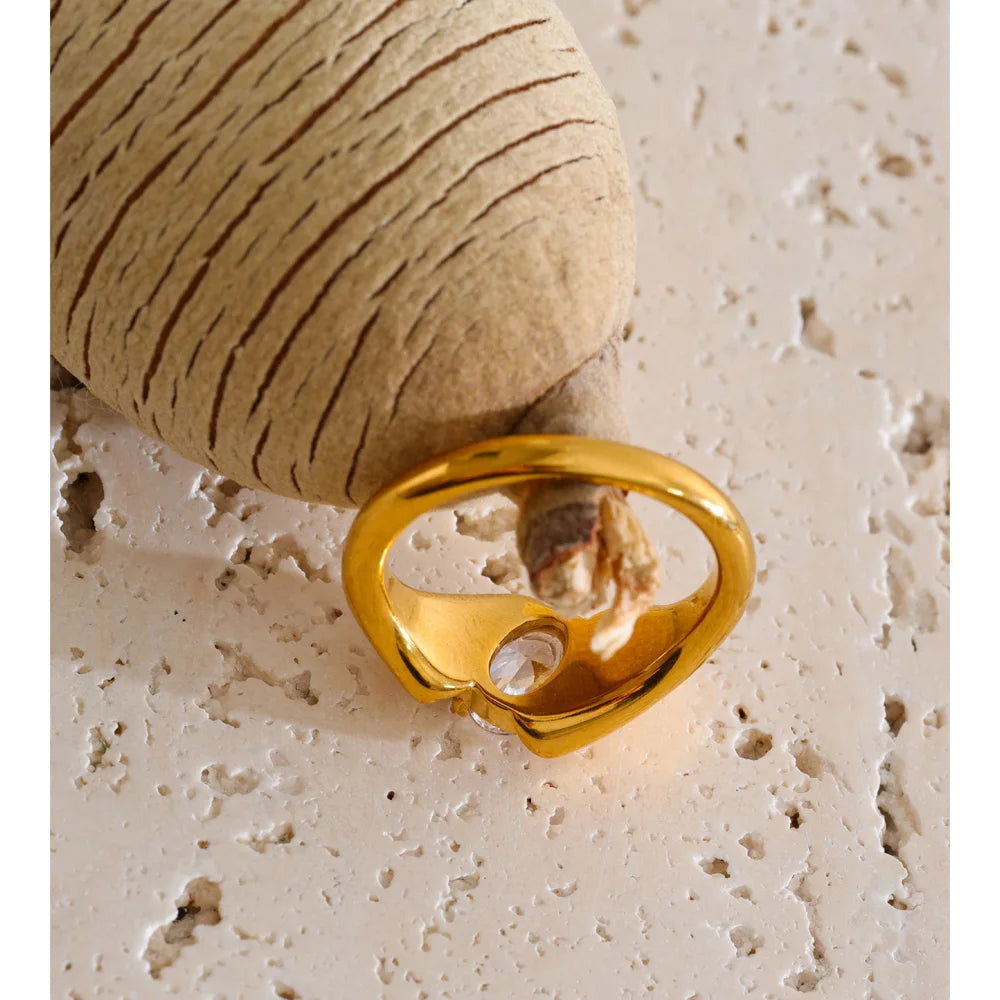 Cubic zirconia geometric ring in 18K gold-plated stainless steel with cubic zirconia.