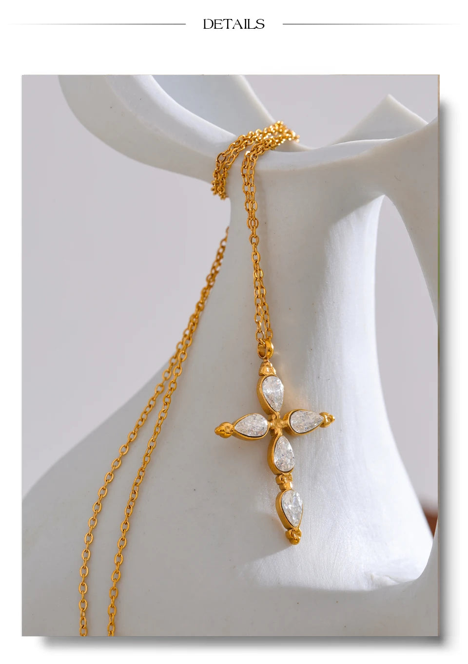 Cubic zirconia cross necklace in gold-plated stainless steel with cubic zirconia.