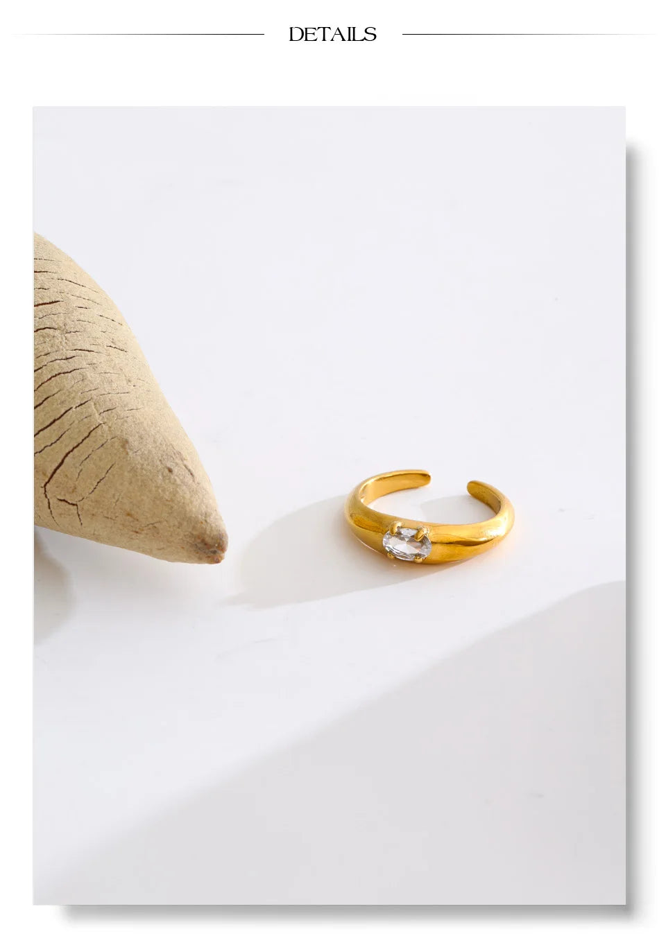 Cubic zirconia geometric ring in 18K gold-plated stainless steel with cubic zirconia.