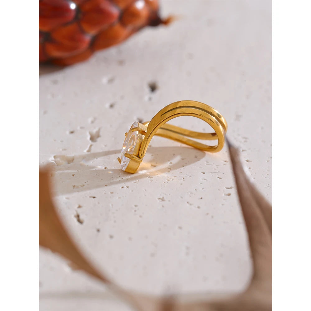 Cubic zirconia geometric ring in 18K gold-plated stainless steel with cubic zirconia.