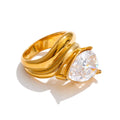 Cubic zirconia geometric ring in 18K gold-plated stainless steel with cubic zirconia.
