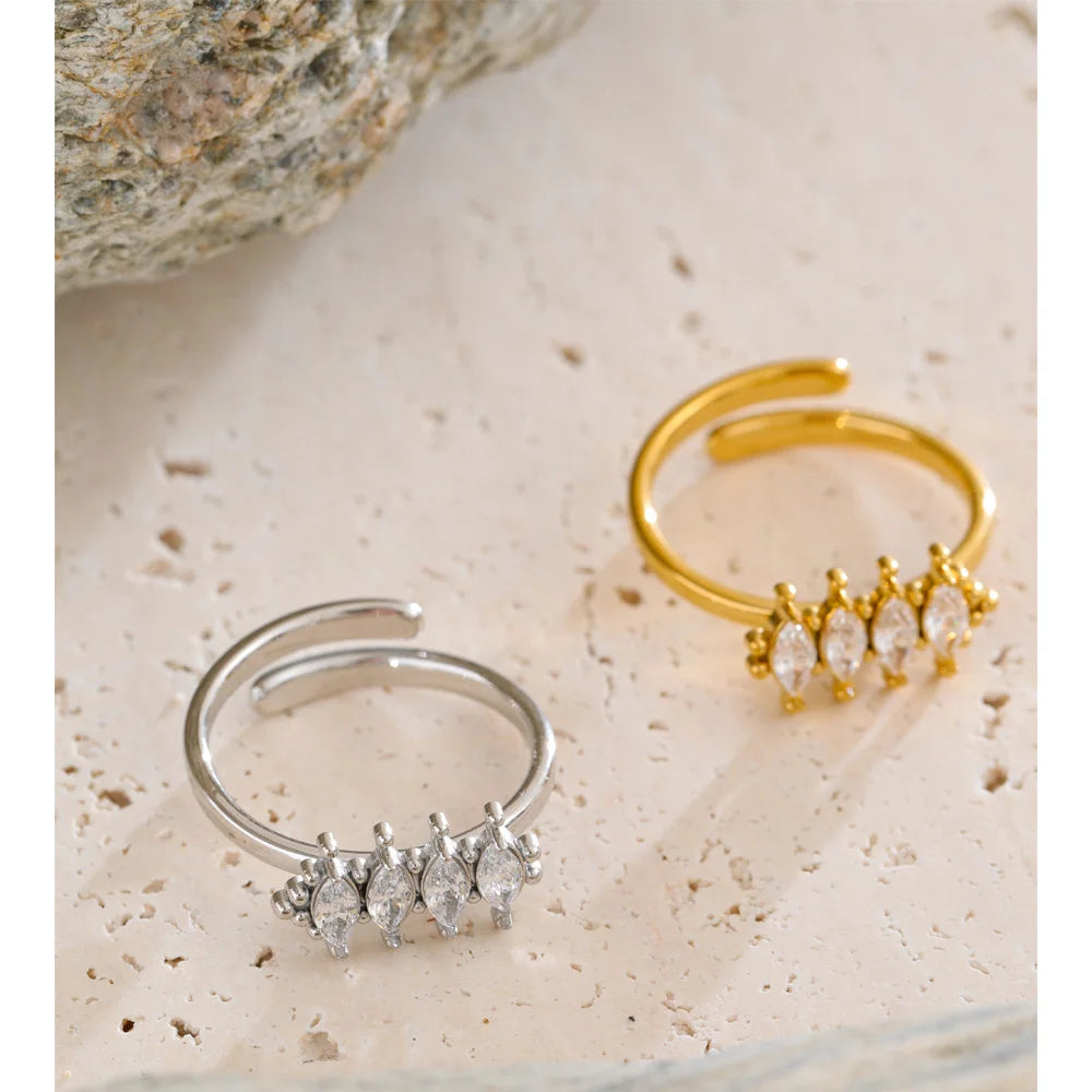 Cubic zirconia geometric ring in 18K gold-plated stainless steel with cubic zirconia.