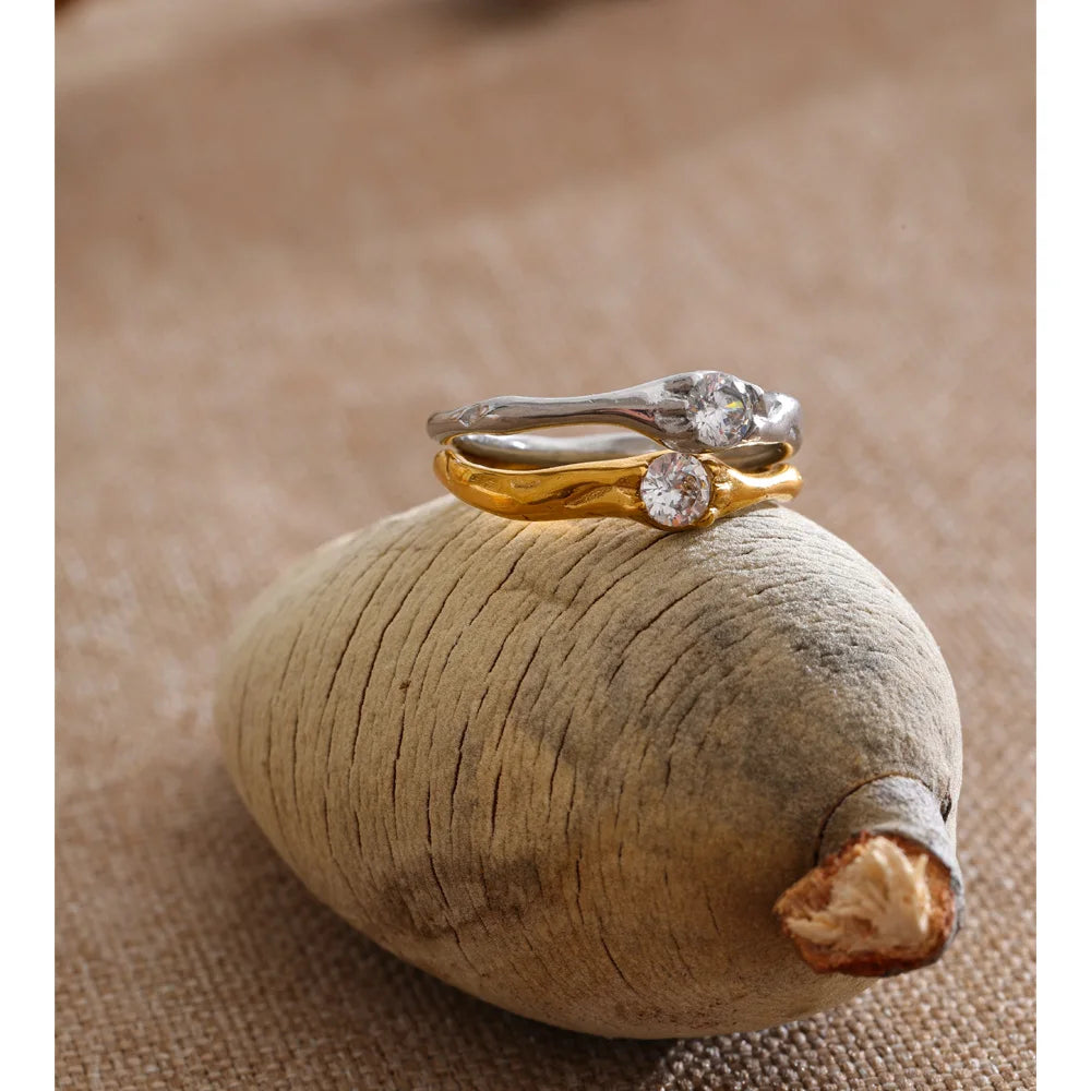 Cubic zirconia geometric ring in 18K gold-plated stainless steel with cubic zirconia.