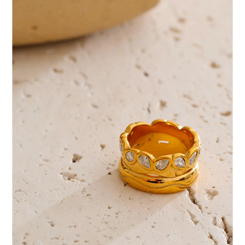 Cubic zirconia geometric ring in 18K gold-plated stainless steel with cubic zirconia.
