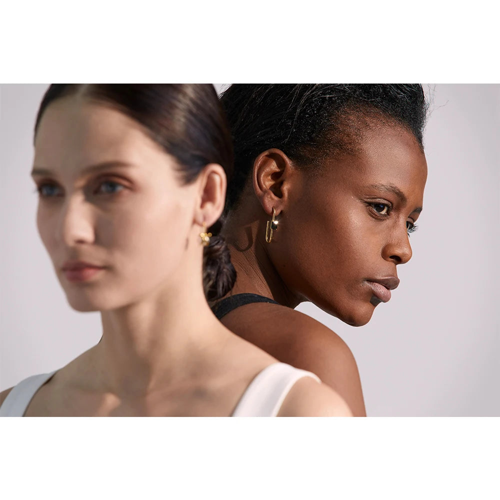 Black cubic zirconia geometric earrings in 18K gold-plated stainless steel with cubic zirconia.