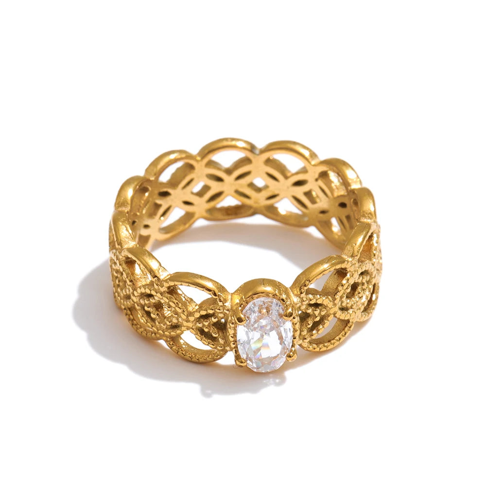 Cubic zirconia geometric ring in 18K gold-plated stainless steel with cubic zirconia.