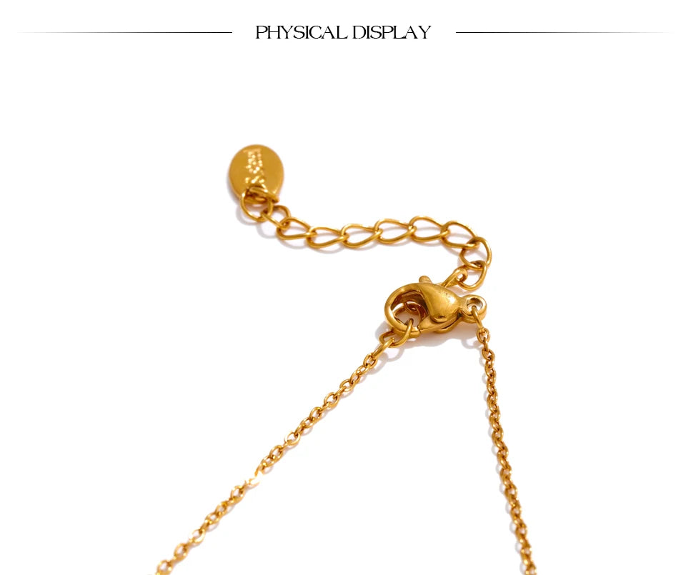 Cubic zirconia cross necklace in gold-plated stainless steel with cubic zirconia.