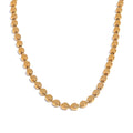 Gold-plated stainless steel necklace with circular beads.
