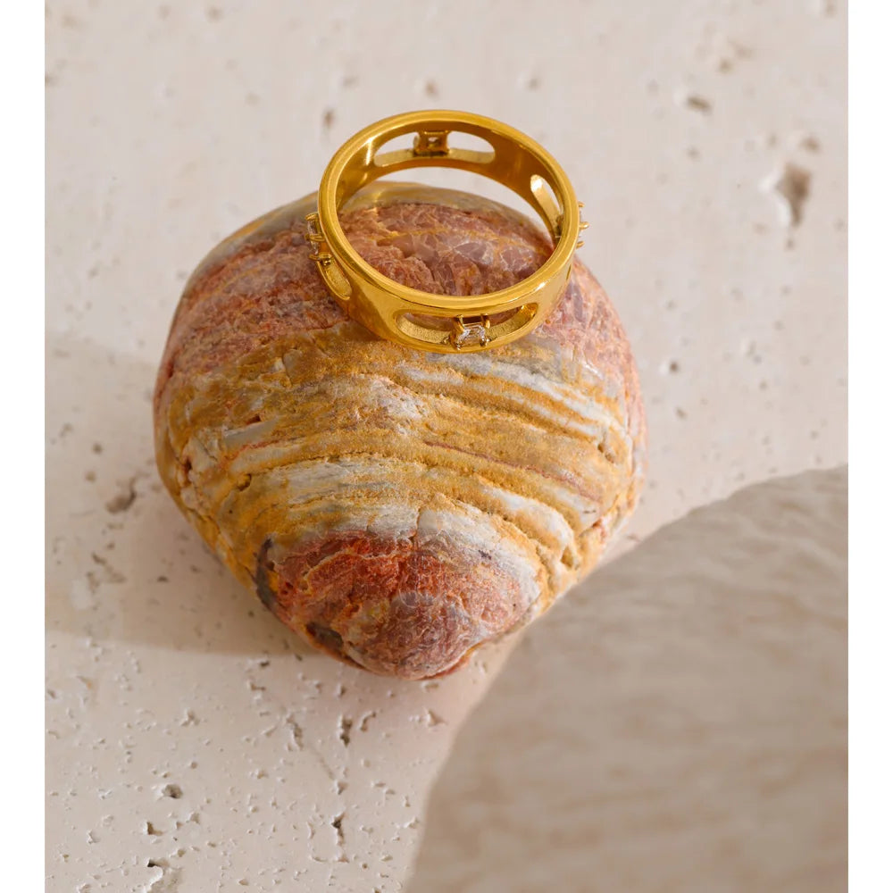 Cubic zirconia geometric ring in 18K gold-plated stainless steel with cubic zirconia.