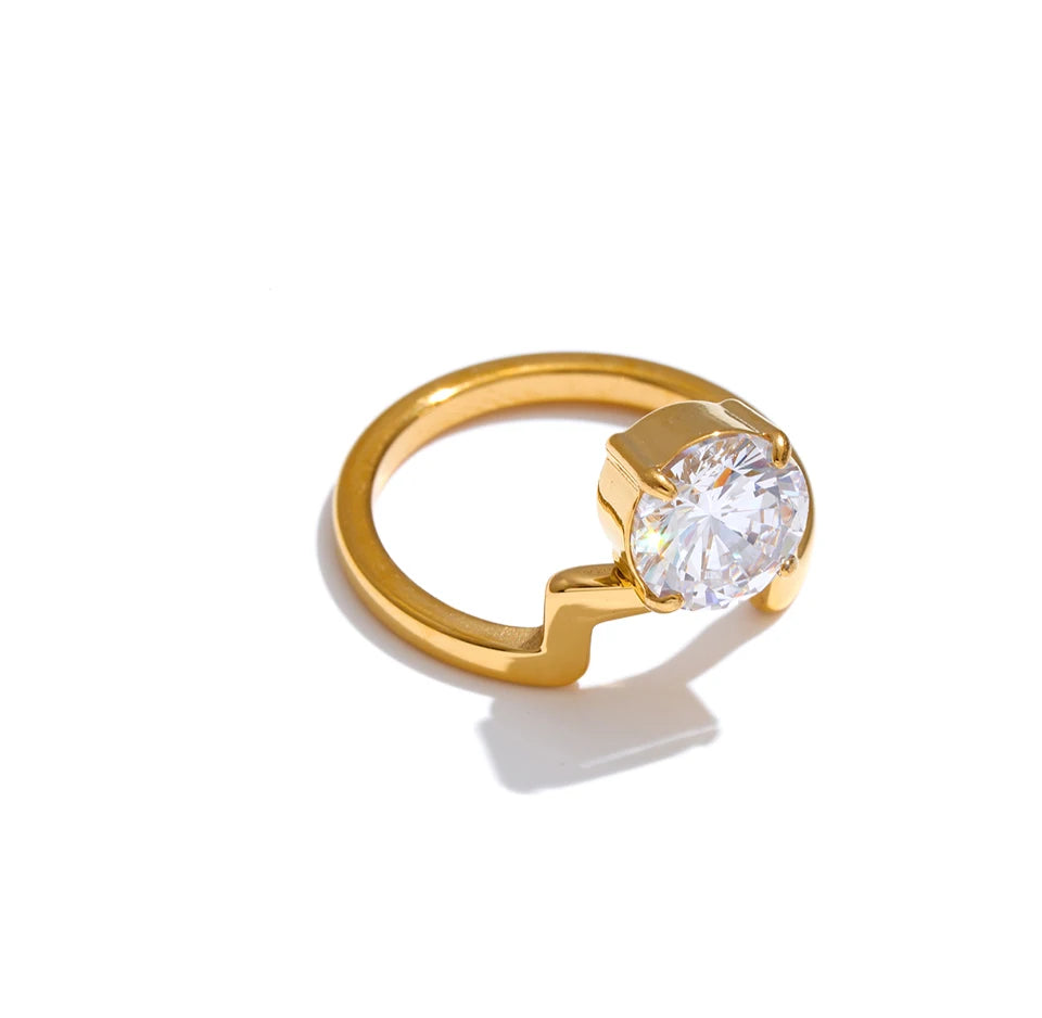 Cubic zirconia geometric ring in 18K gold-plated stainless steel with cubic zirconia.