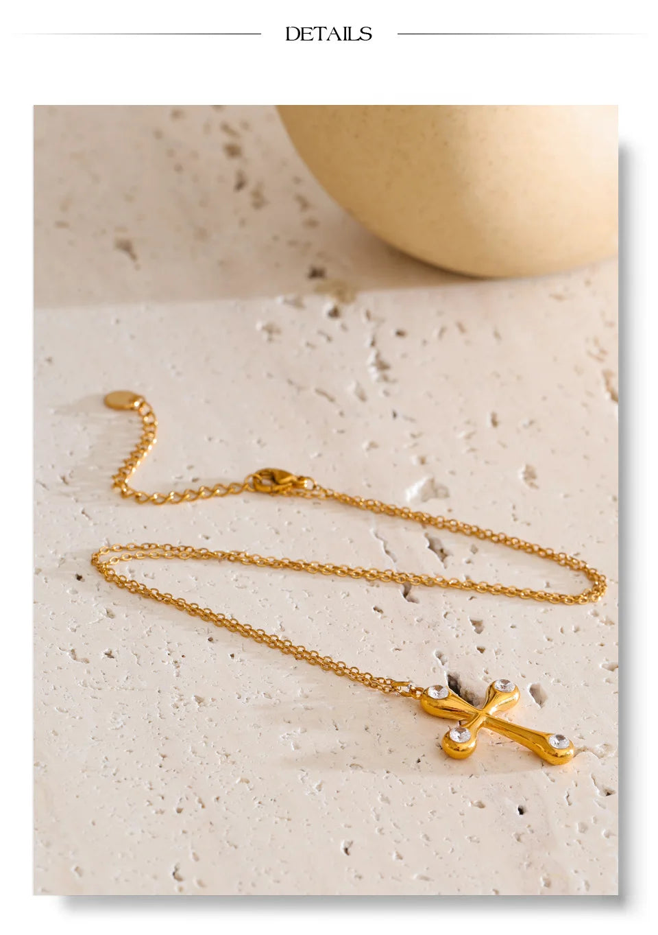 Cubic zirconia cross necklace in gold-plated stainless steel with cubic zirconia.