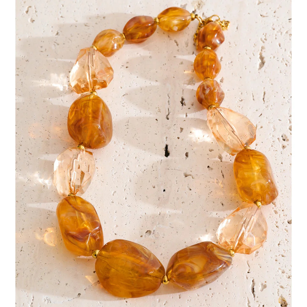 Resin acrylic geometric necklace in gold-plated stainless steel with resin and acrylic.