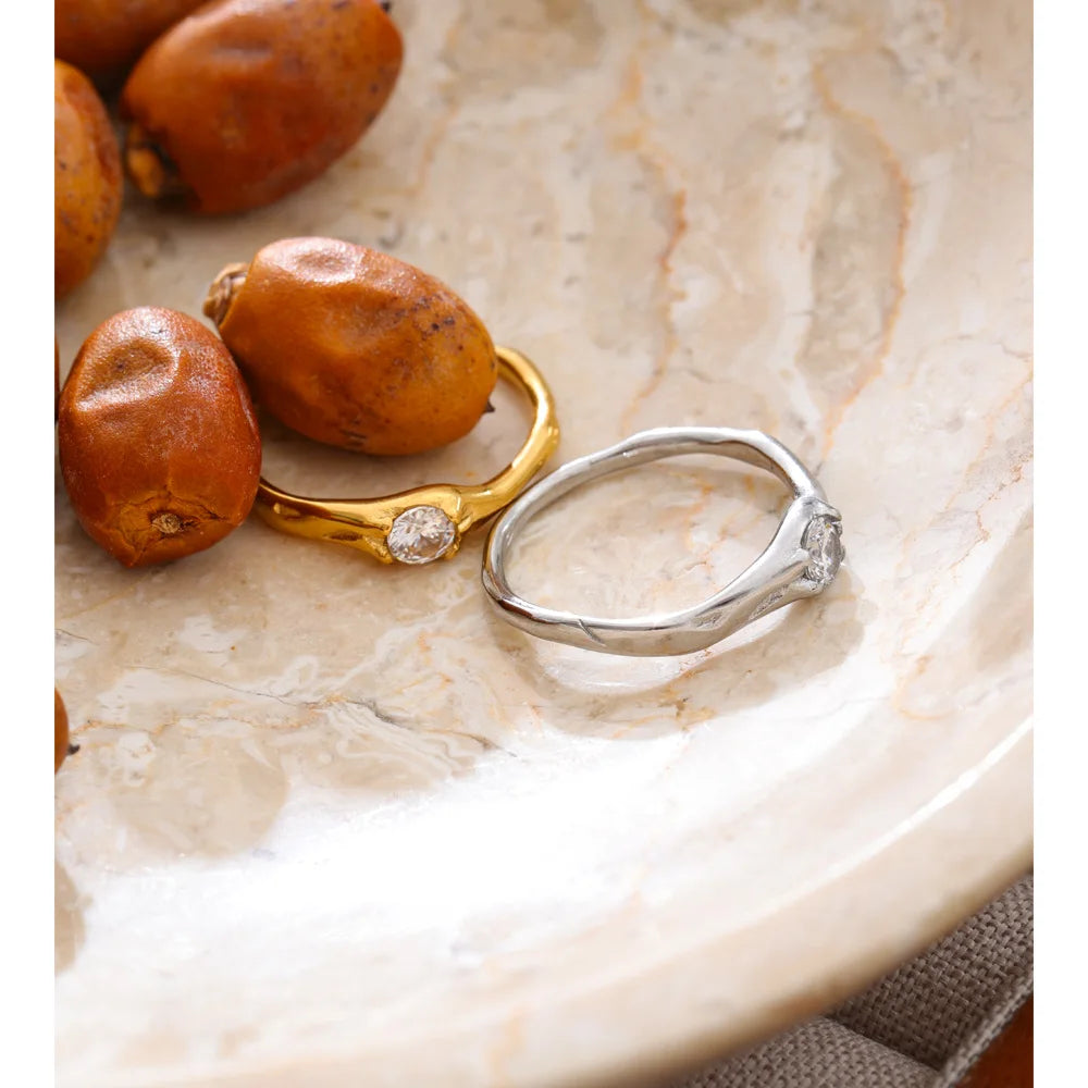 Cubic zirconia geometric ring in 18K gold-plated stainless steel with cubic zirconia.