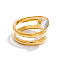 Cubic zirconia geometric layered ring in 18K gold-plated stainless steel with cubic zirconia.