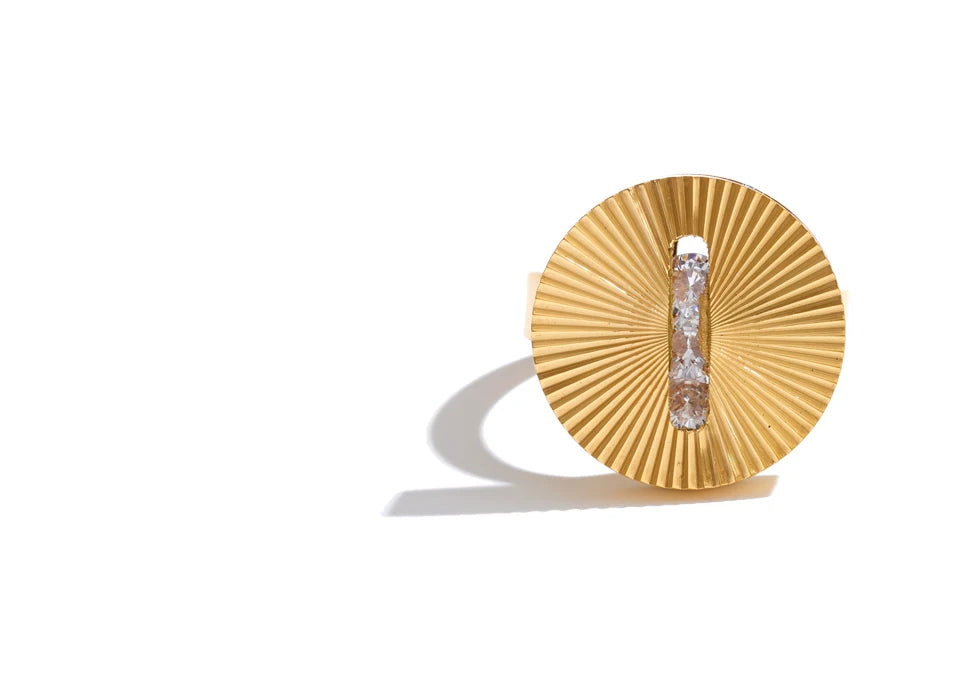 Cubic zirconia geometric ring in 18K gold-plated stainless steel with cubic zirconia.