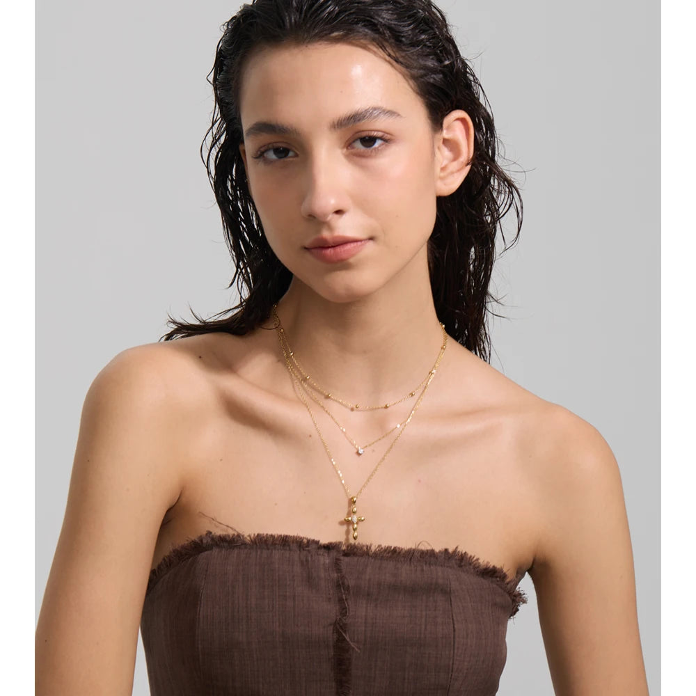 Cubic zirconia cross chain necklace in gold-plated stainless steel with cubic zirconia.