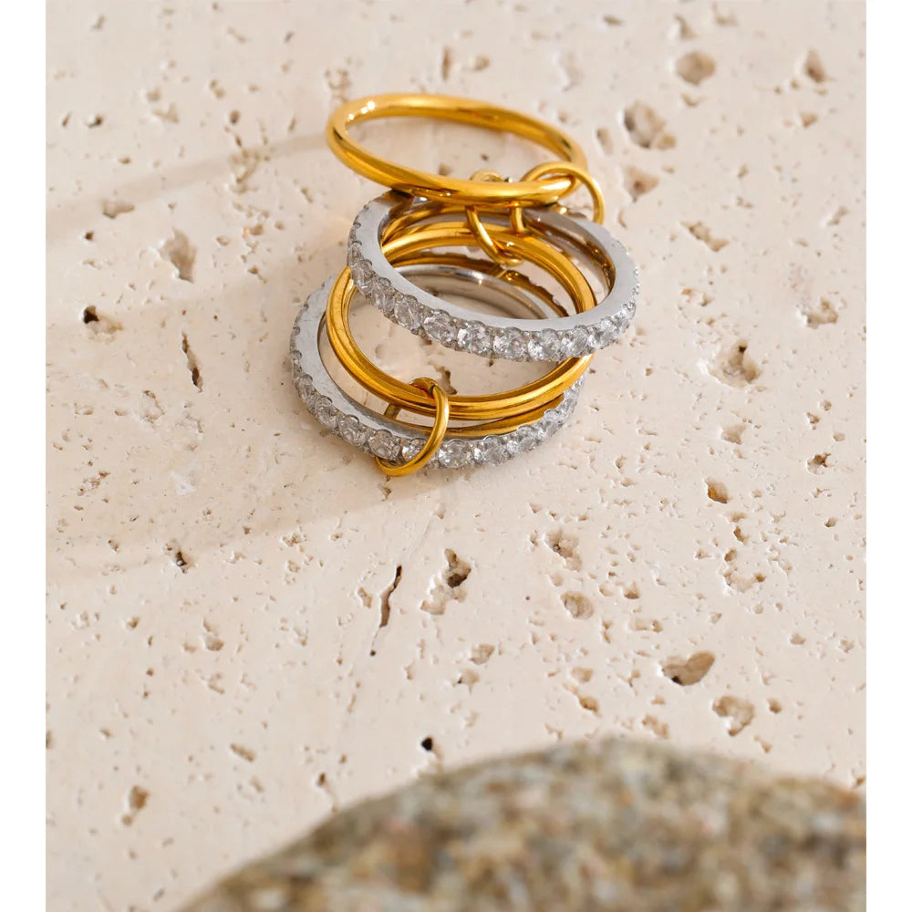 Cubic zirconia geometric layered ring in 18K gold-plated stainless steel with cubic zirconia.