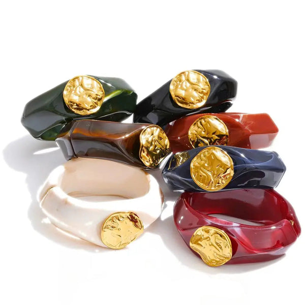 Gold-plated stainless steel bracelet with resin, featuring a large gold-plated charm in the center.