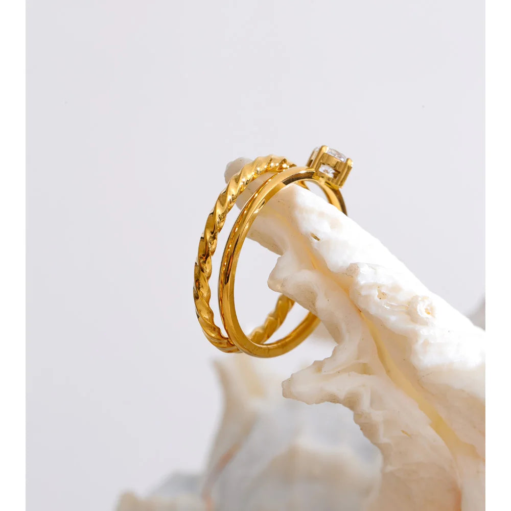 Cubic zirconia geometric ring in gold-plated stainless steel with cubic zirconia.