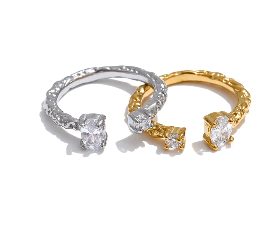 Cubic zirconia geometric ring in 18K gold-plated stainless steel with cubic zirconia.