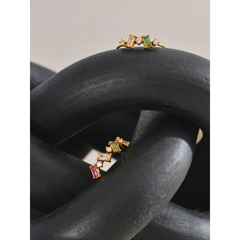 Cubic zirconia multi-color geometric ring in 18K gold-plated stainless steel with cubic zirconia.