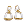 White enamel geometric earrings in gold-plated stainless steel with enamel.