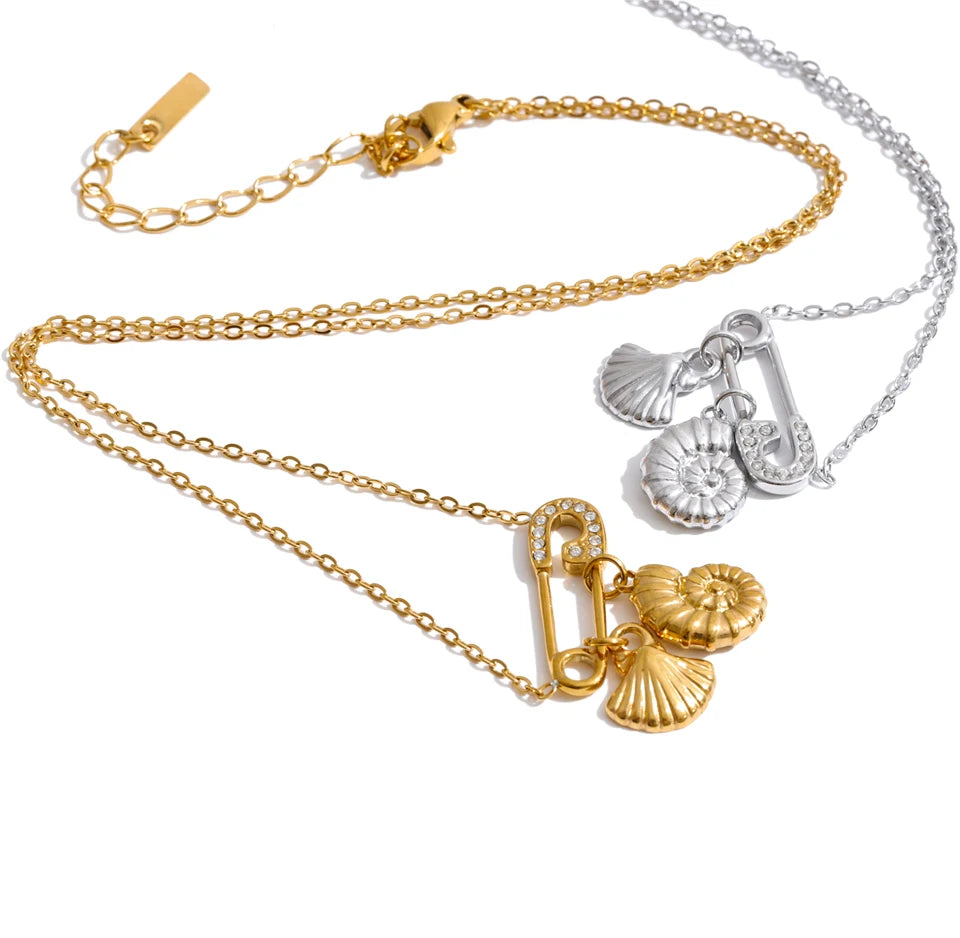 Cubic zirconia shell geometric necklace in gold-plated stainless steel with cubic zirconia and shell.